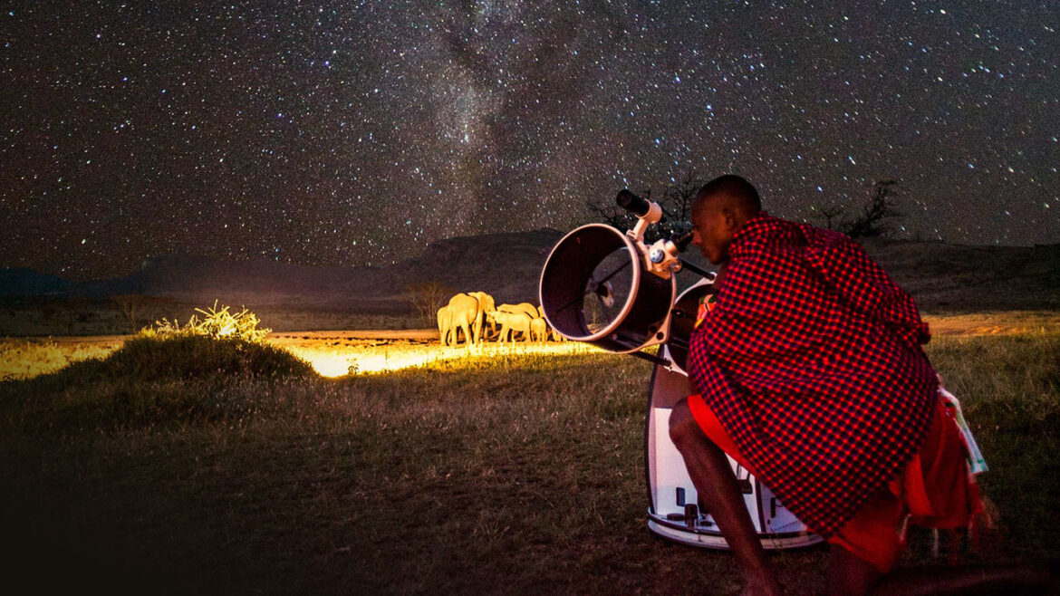 A Maasai man doinng Stargazing at night. Photo: Getty Images.