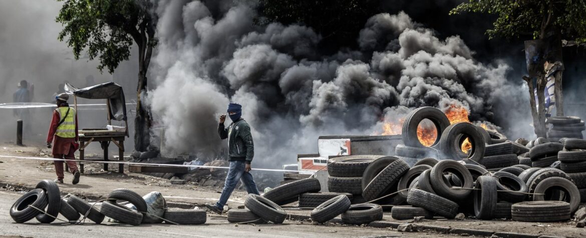 A protester walks past a burning barricade made of tyres during clashes with Kenya police officers at Saba Saba Day demonstrations in Nairobi on July 7, 2025. Photo: AP Photo