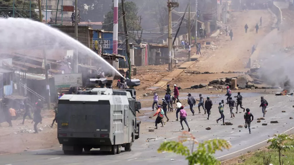 Anti-Riot Police officers battle protesters in Nairobi. Photo: AP